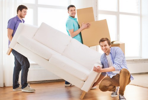 Professional movers handling office furniture